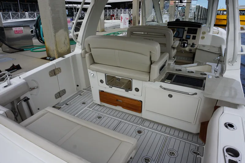 Iboat 3 Yacht Photos Pics 2019 Boston Whaler 350 Realm boat interior with seating and helm station.