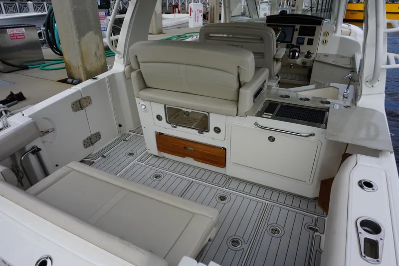 Iboat 3 Yacht Photos Pics 2019 Boston Whaler 350 Realm interior with seating and helm, showcasing luxury and functionality.