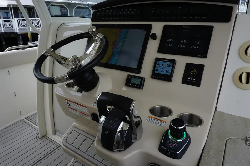 Iboat 3 Yacht Photos Pics 2019 Boston Whaler 350 Realm helm with advanced navigation controls and steering wheel.