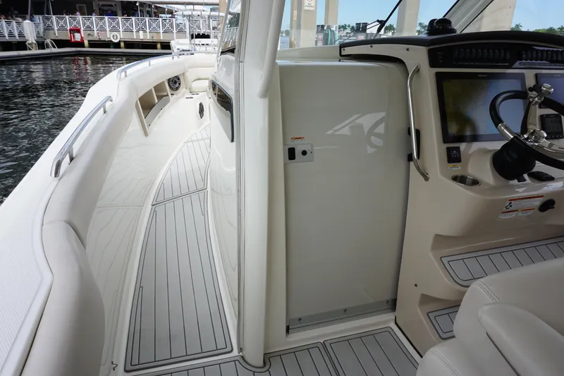Iboat 3 Yacht Photos Pics 2019 Boston Whaler 350 Realm boat interior with helm and seating area.