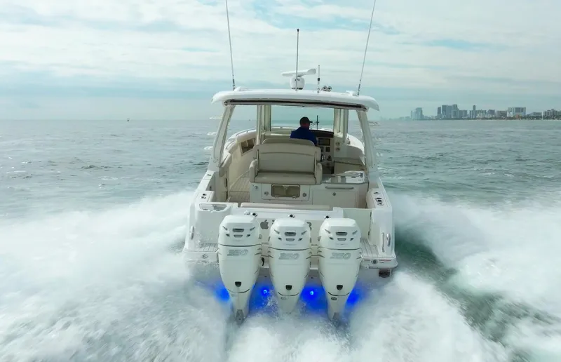 Iboat 3 Yacht Photos Pics 2019 Boston Whaler 350 Realm cruising on open water with triple engines.