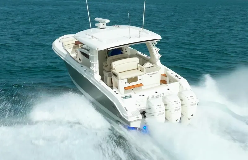 Iboat 3 Yacht Photos Pics 2019 Boston Whaler 350 Realm cruising on open water, showcasing powerful triple engines.