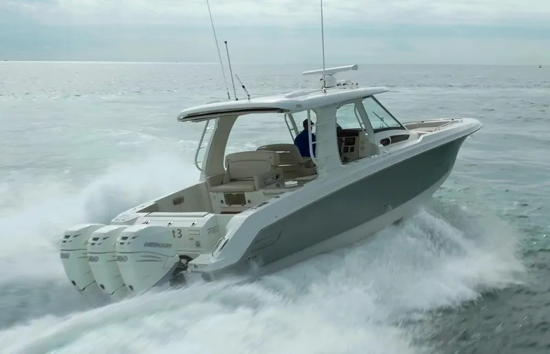 Iboat 3 Yacht Photos Pics 2019 Boston Whaler 350 Realm cruising on open water, showcasing powerful engines and sleek design.