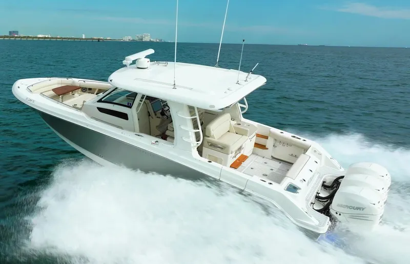 Iboat 3 Yacht Photos Pics 2019 Boston Whaler 350 Realm cruising on open water, showcasing sleek design and powerful engines.