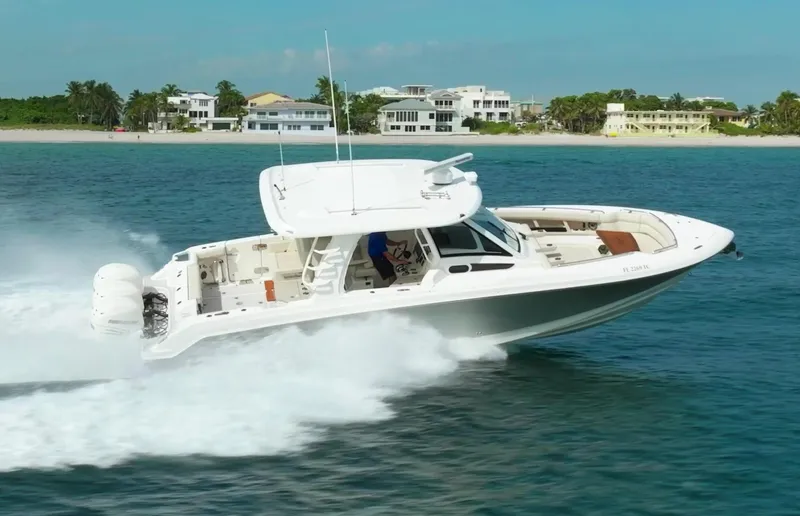 Iboat 3 Yacht Photos Pics 2019 Boston Whaler 350 Realm cruising on ocean near beachfront homes.