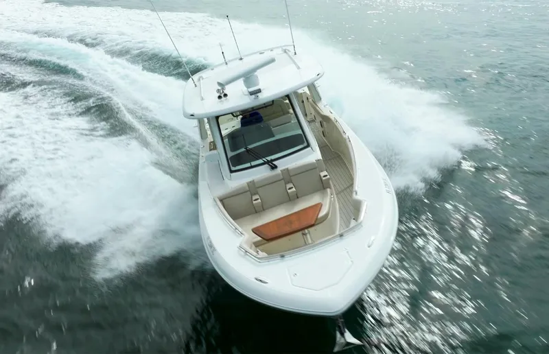 Iboat 3 Yacht Photos Pics 2019 Boston Whaler 350 Realm cruising on open water, aerial view.