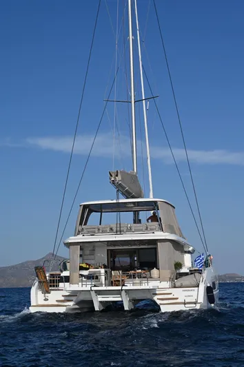 Esperance Yacht Photos Pics 2024 Lagoon 55 catamaran sailing on open sea under clear blue sky.