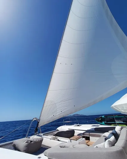 Esperance Yacht Photos Pics 2024 Lagoon 55 yacht sailing on open sea under clear blue sky.