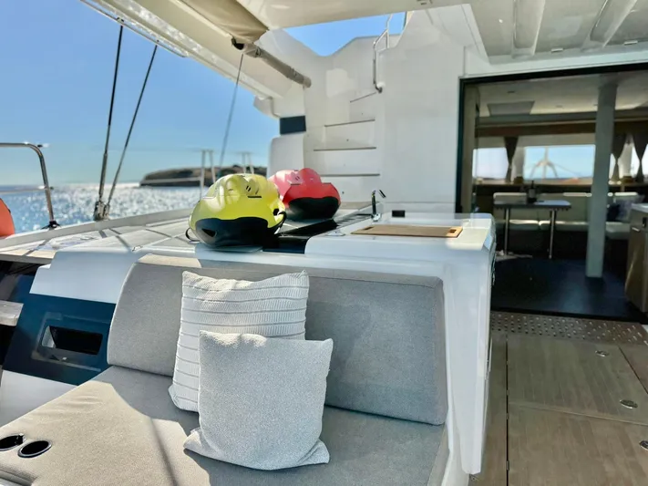 Esperance Yacht Photos Pics Luxurious 2024 Lagoon 55 yacht interior with cushions and sea view.