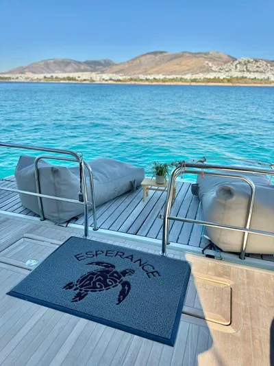 Esperance Yacht Photos Pics Luxury Lagoon 55 yacht deck with ocean view, featuring comfortable seating and decorative mat.