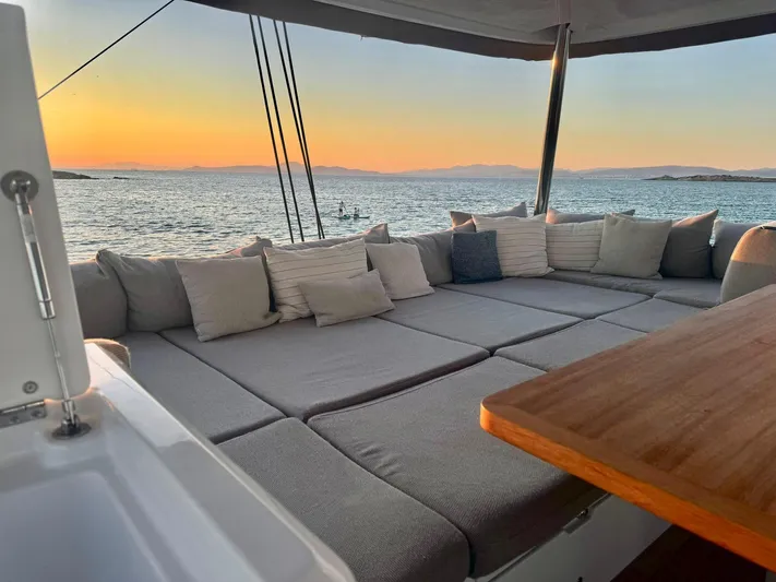Esperance Yacht Photos Pics Luxurious Lagoon 55 yacht deck with cushions, sunset ocean view, 2024 model.