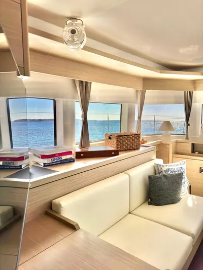 Esperance Yacht Photos Pics Luxurious interior of 2024 Lagoon 55 yacht with ocean view through large windows.