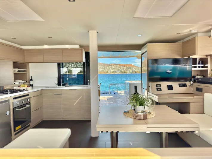 Esperance Yacht Photos Pics Luxurious interior of 2024 Lagoon 55 yacht with modern kitchen and scenic ocean view.