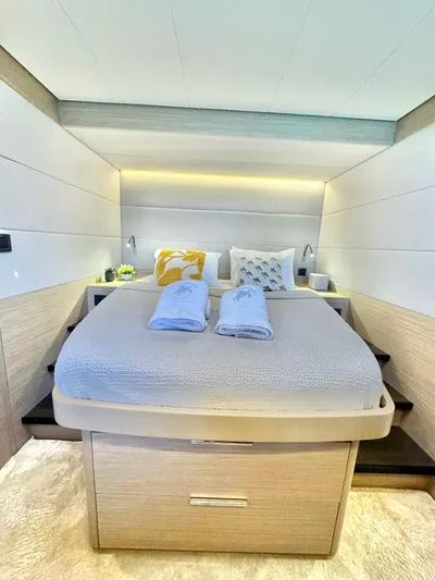 Esperance Yacht Photos Pics Luxurious bedroom interior of 2024 Lagoon 55 yacht with modern design and cozy bedding.