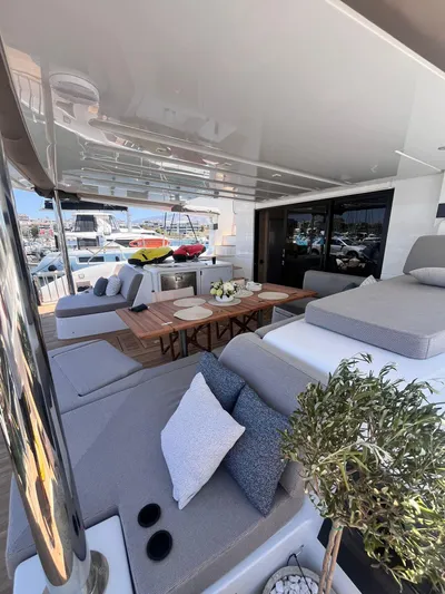 Esperance Yacht Photos Pics Luxurious 2024 Lagoon 55 yacht interior with elegant seating and dining area.