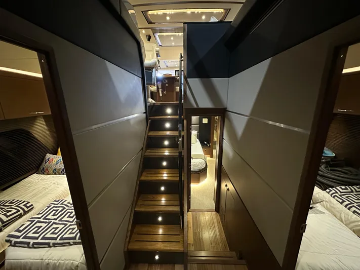Flawless Yacht Photos Pics Luxurious interior of 2015 Sea Ray L650 Fly yacht with elegant wooden stairs and cozy bedrooms.