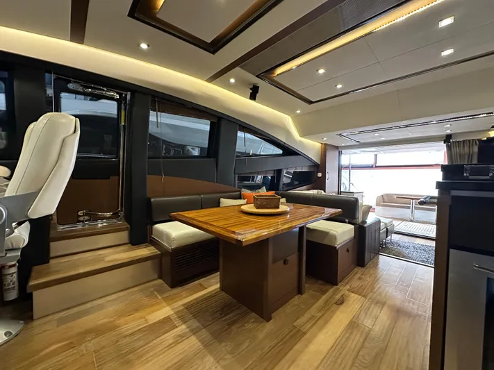 Flawless Yacht Photos Pics Luxurious interior of a 2015 Sea Ray L650 Fly yacht with elegant wood flooring and modern seating.