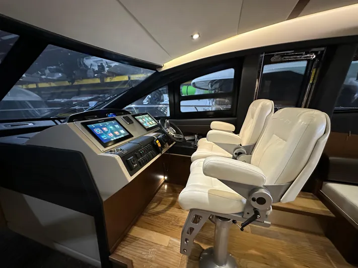 Flawless Yacht Photos Pics Interior helm of 2015 Sea Ray L650 Fly yacht with modern controls and plush seating.