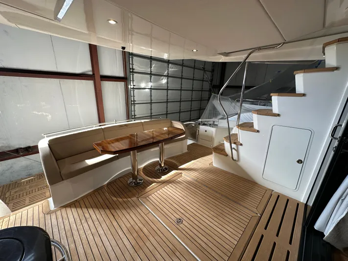 Flawless Yacht Photos Pics Luxurious 2015 Sea Ray L650 Fly yacht interior with wooden flooring and elegant seating area.