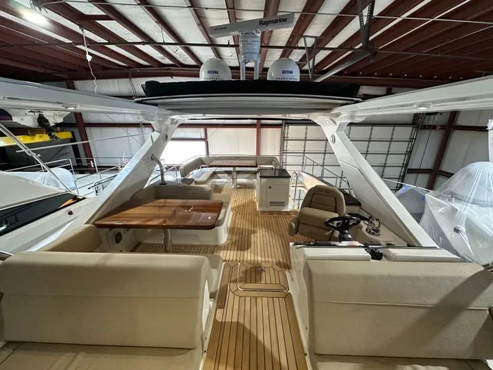 Flawless Yacht Photos Pics 2015 Sea Ray L650 Fly yacht interior with spacious seating and wooden deck.