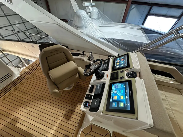 Flawless Yacht Photos Pics 2015 Sea Ray L650 Flybridge helm with dual screens and captain's chair.