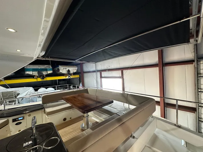 Flawless Yacht Photos Pics 2015 Sea Ray L650 Fly yacht interior with seating and table in a covered area.