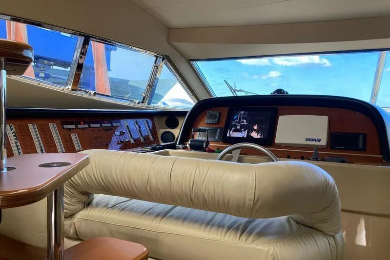  Yacht Photos Pics 2004 Ferretti Yachts 590 helm with leather seating and advanced navigation controls.