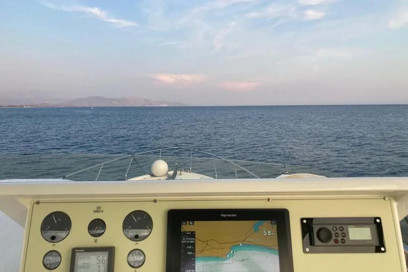  Yacht Photos Pics Helm view from 2004 Ferretti Yachts 590, showcasing navigation instruments and open sea.