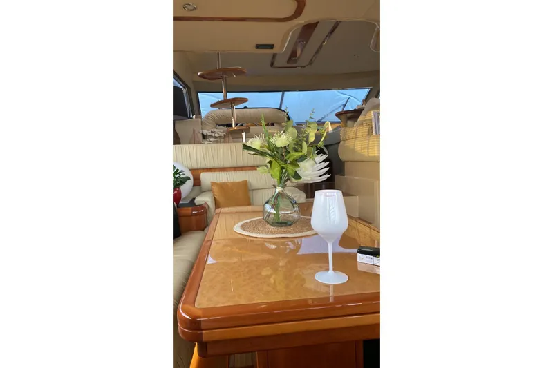  Yacht Photos Pics Luxurious interior of 2004 Ferretti Yachts 590 with elegant table setting and floral arrangement.