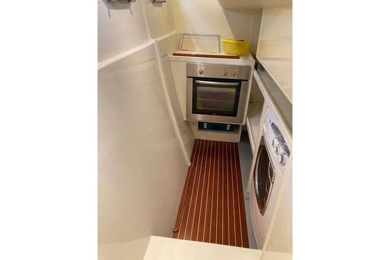  Yacht Photos Pics Compact kitchen in 2004 Ferretti Yachts 590 with oven and washing machine.