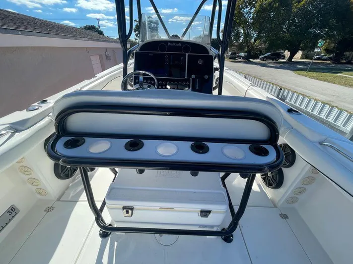  Yacht Photos Pics 2006 Wellcraft 32 CCF boat interior with seating and control panel, under clear blue sky.