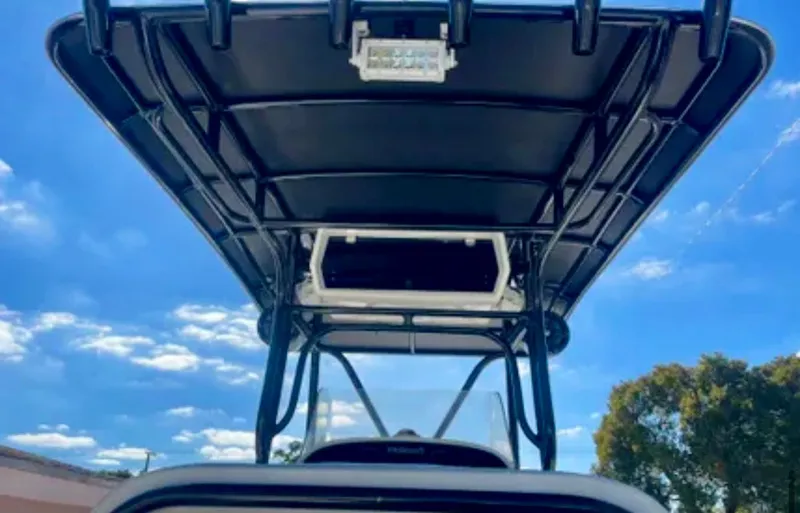  Yacht Photos Pics 2006 Wellcraft 32 CCF boat with T-top against a clear blue sky.