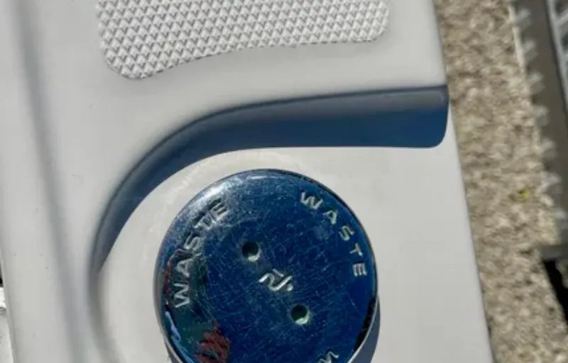  Yacht Photos Pics Waste cap on 2006 Wellcraft 32 CCF boat, featuring textured surface and blue detailing.