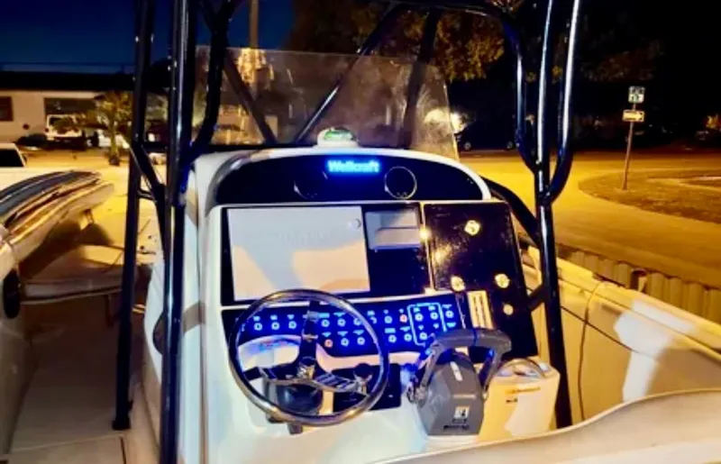  Yacht Photos Pics 2006 Wellcraft 32 CCF boat console at night, illuminated controls and steering wheel.