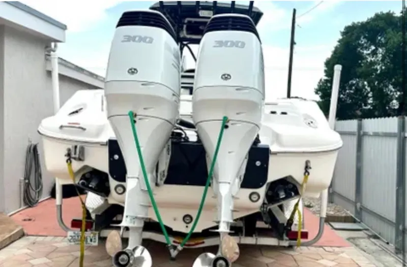  Yacht Photos Pics 2006 Wellcraft 32 CCF boat with dual 300 horsepower outboard engines, parked on a driveway.