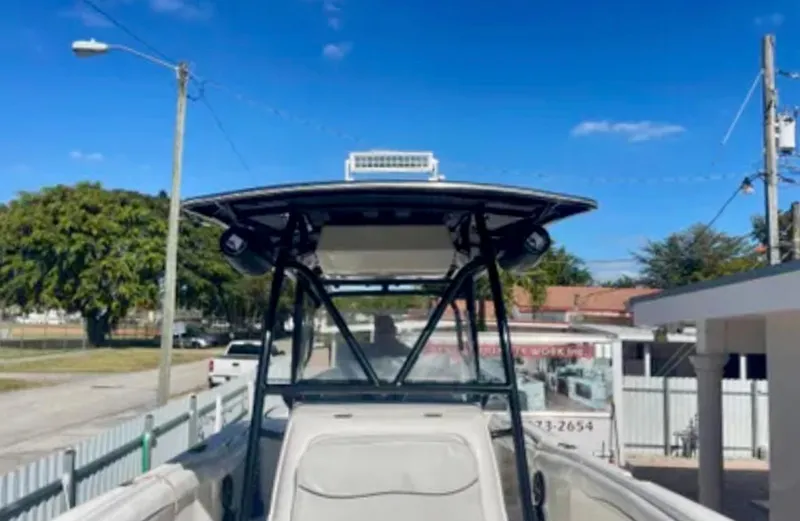  Yacht Photos Pics 2006 Wellcraft 32 CCF boat with T-top, parked outdoors under clear blue sky.