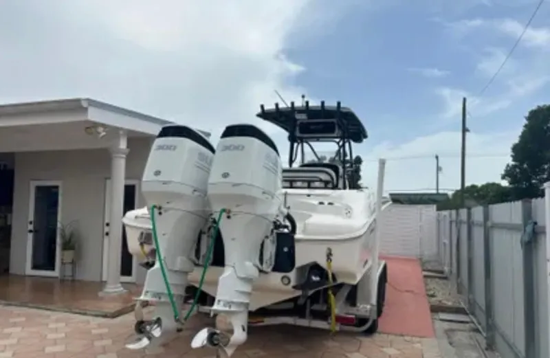  Yacht Photos Pics 2006 Wellcraft 32 CCF boat with dual engines parked in a driveway.