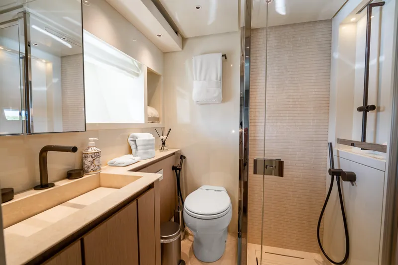  Yacht Photos Pics Luxurious bathroom in 2021 Sanlorenzo SX76 yacht with modern fixtures and elegant design.