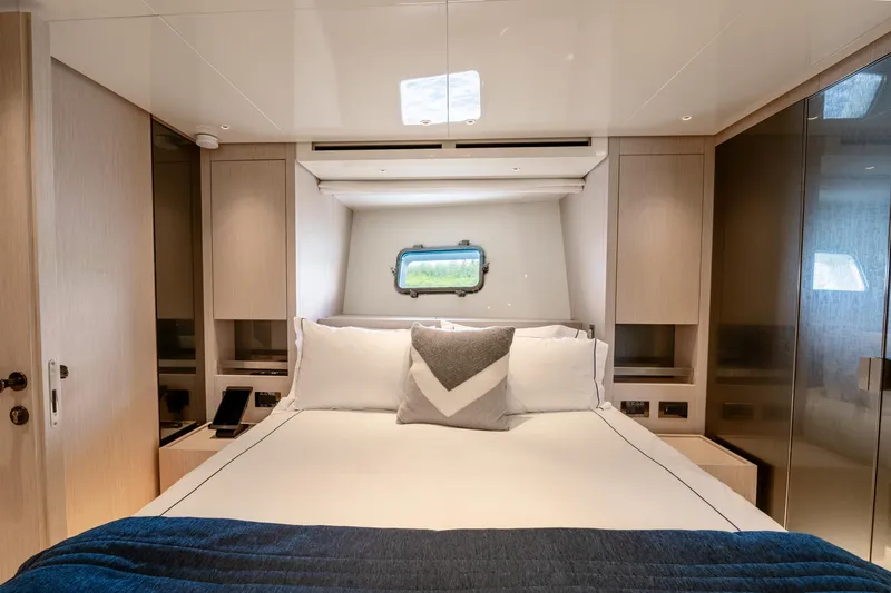  Yacht Photos Pics Luxurious bedroom interior of 2021 Sanlorenzo SX76 yacht with modern design and cozy bedding.
