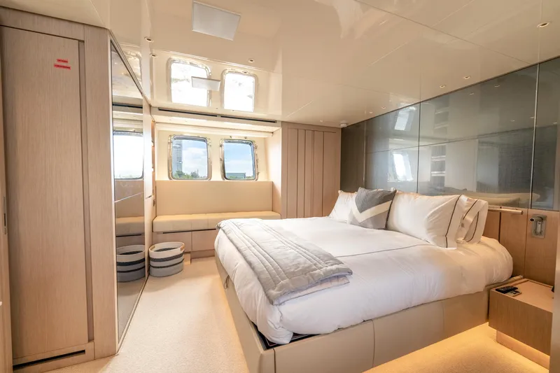  Yacht Photos Pics Luxurious bedroom interior of 2021 Sanlorenzo SX76 yacht with modern design and large windows.