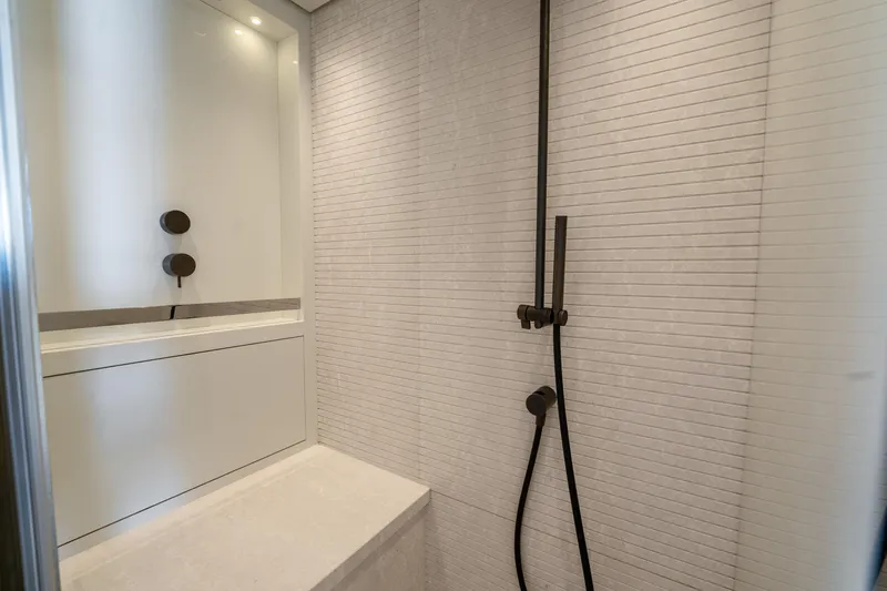  Yacht Photos Pics Modern bathroom shower in 2021 Sanlorenzo SX76 yacht, featuring sleek fixtures and minimalist design.