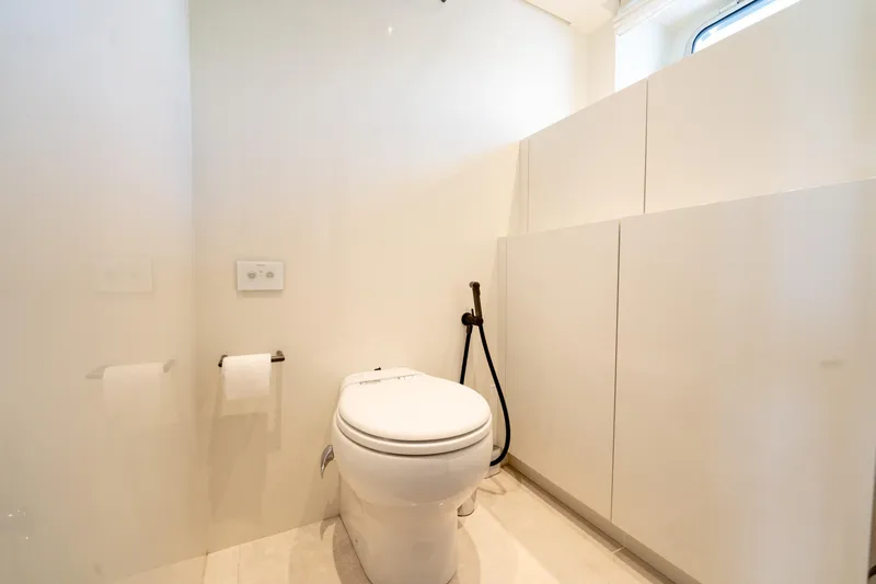  Yacht Photos Pics Modern bathroom on 2021 Sanlorenzo SX76 yacht, featuring sleek white design and contemporary fixtures.