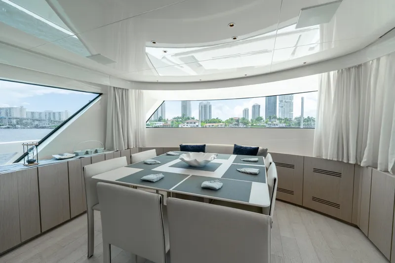  Yacht Photos Pics Luxurious dining area on 2021 Sanlorenzo SX76 yacht with cityscape view.