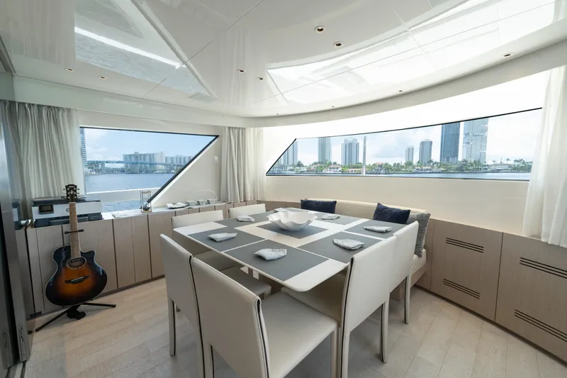  Yacht Photos Pics Luxurious dining area on 2021 Sanlorenzo SX76 yacht with cityscape view.