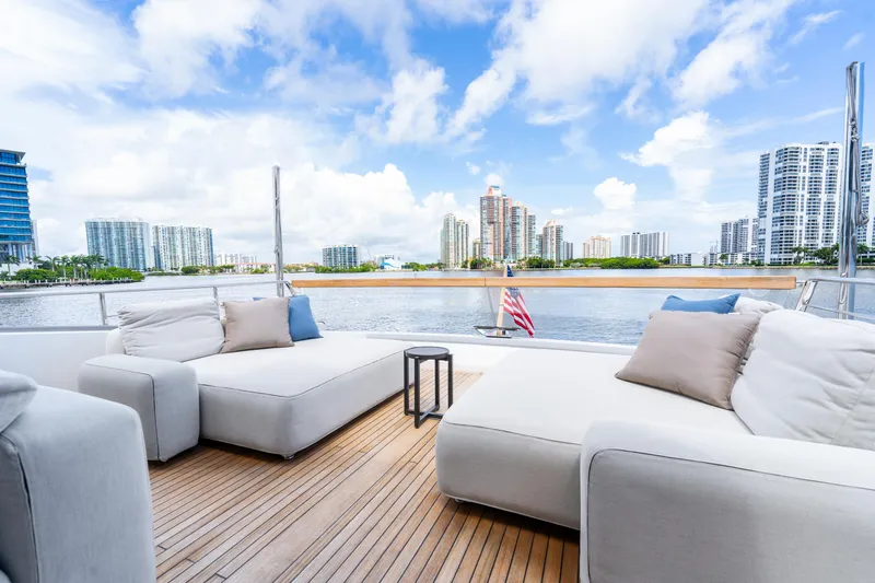  Yacht Photos Pics Luxurious 2021 Sanlorenzo SX76 yacht deck with modern seating, city skyline view.