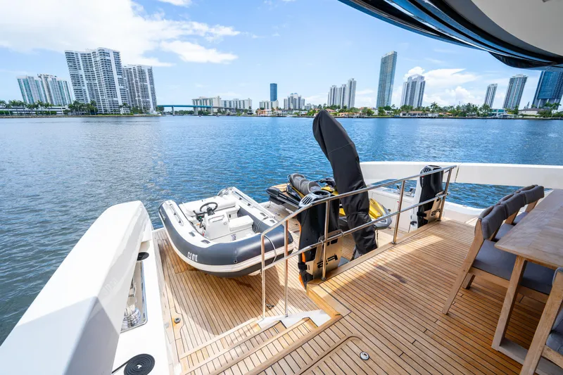  Yacht Photos Pics Sanlorenzo SX76 yacht deck with tender, overlooking city skyline and water, 2021 model.