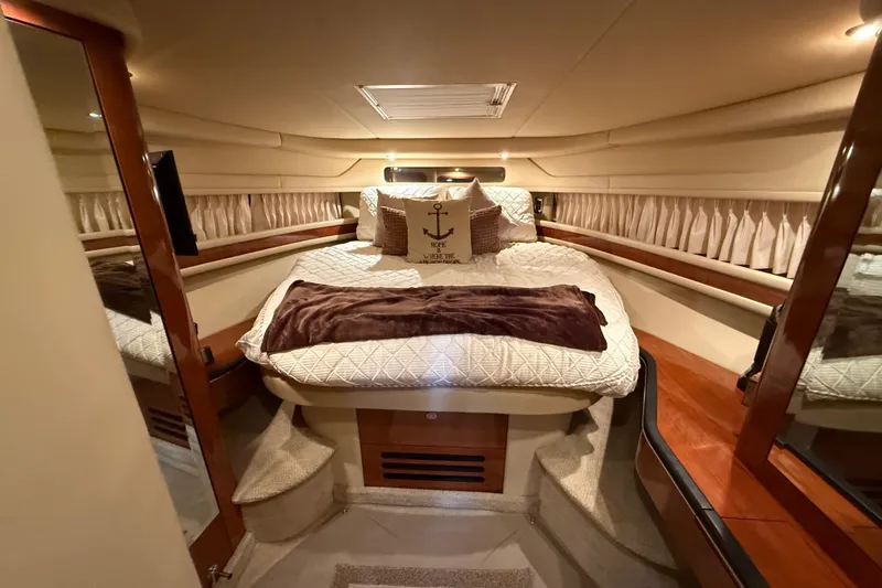  Yacht Photos Pics Luxurious cabin interior of 2004 Sea Ray Sundancer 460 yacht with cozy bedding.