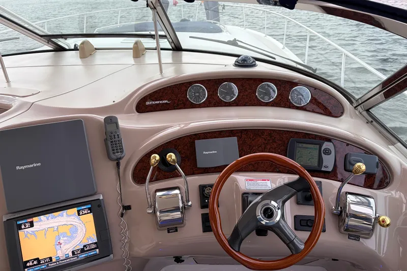  Yacht Photos Pics Cockpit of 2004 Sea Ray Sundancer 460 with navigation equipment and steering wheel.