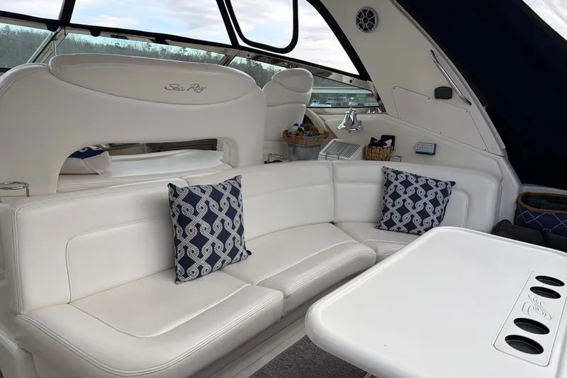  Yacht Photos Pics Luxurious interior of 2004 Sea Ray Sundancer 460 yacht with white seating and decorative pillows.