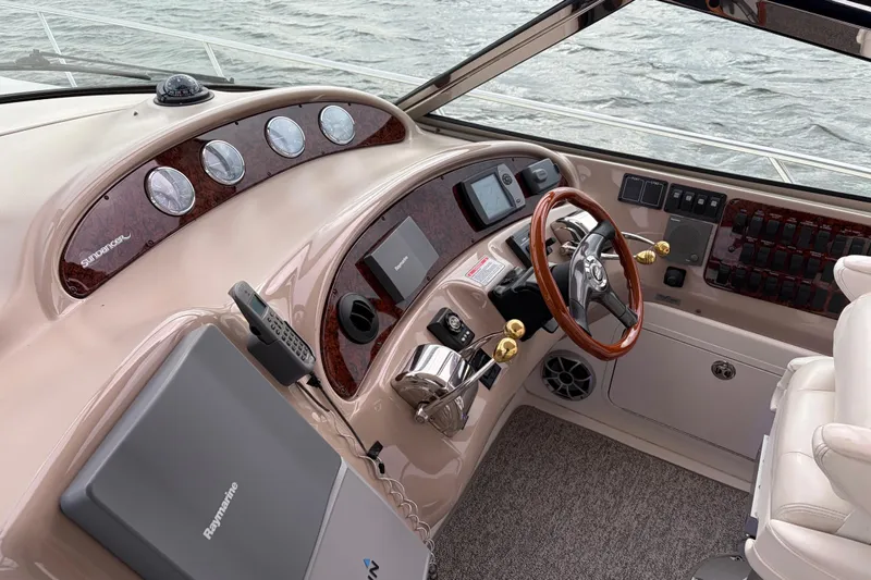  Yacht Photos Pics 2004 Sea Ray Sundancer 460 helm with wood accents and modern navigation equipment.